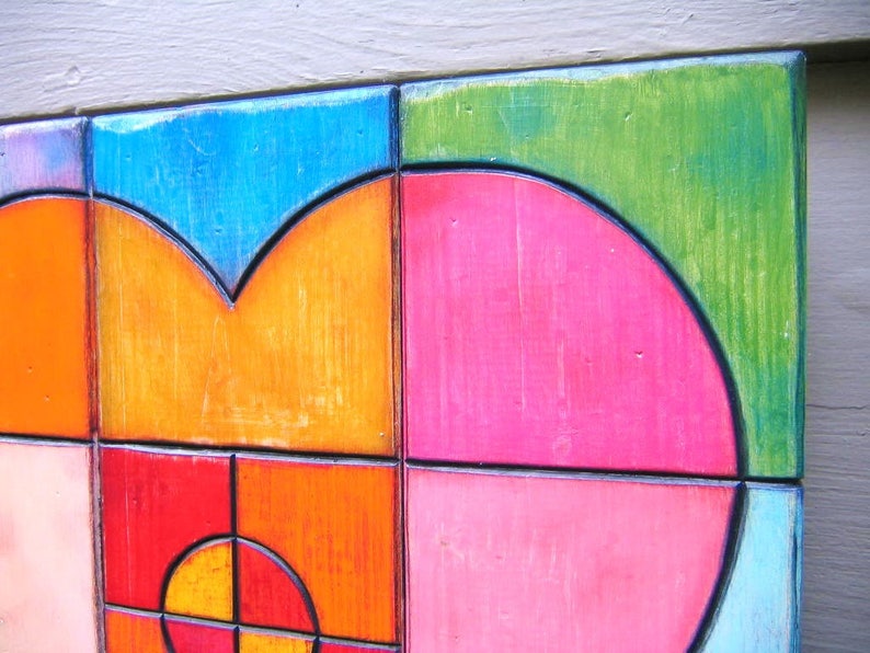 May include: A colorful abstract art piece with geometric shapes and a mix of orange, pink, blue, and green colors.