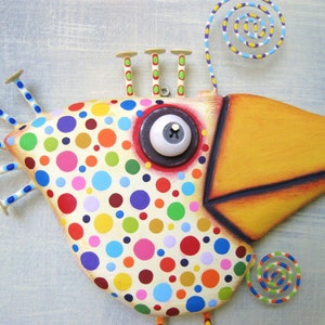 May include: Whimsical, hand-painted bird sculpture with a cream-colored body covered in colorful polka dots. Features a large yellow beak, a single eye, and decorative accents. The bird has a unique, artistic design, perfect for home decor.