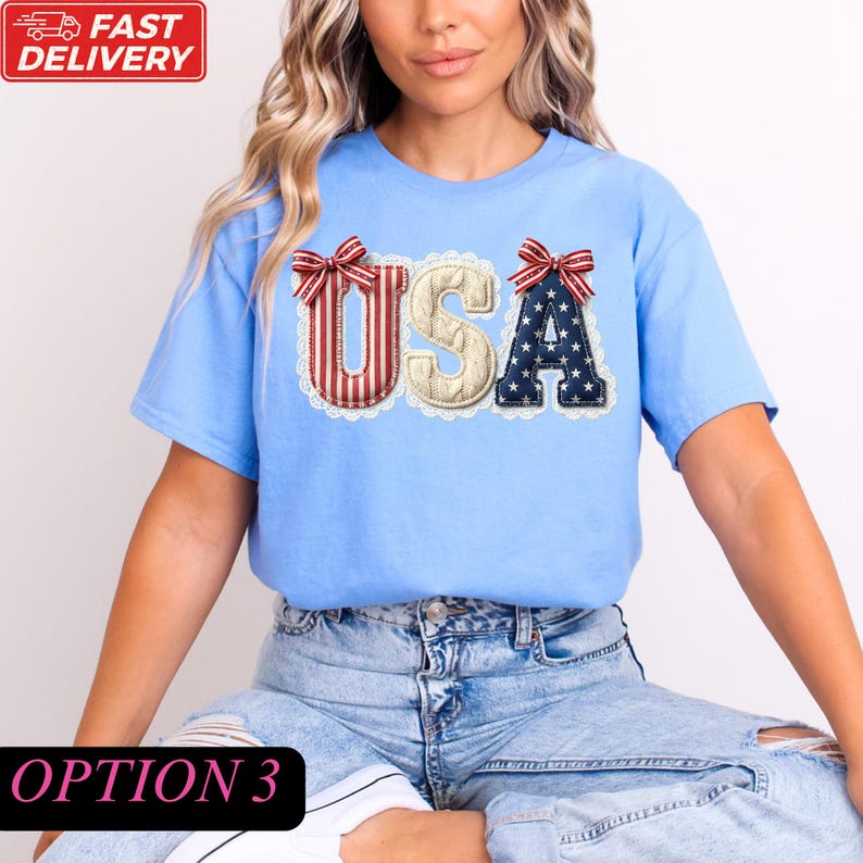 A woman wearing a blue t-shirt with the word "USA" printed on it, along with red and white striped bows.