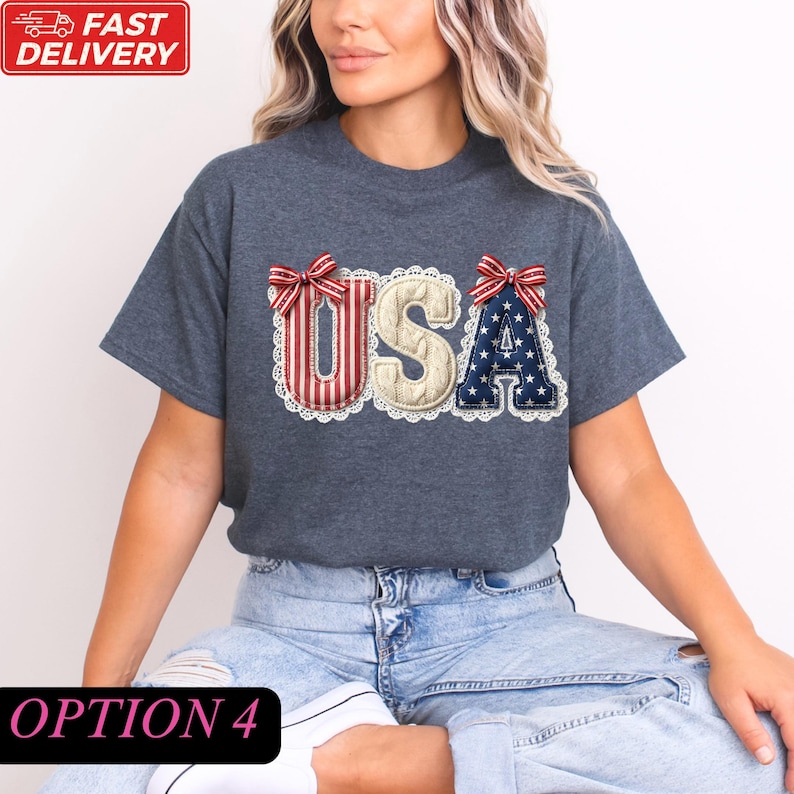 A woman wearing a gray t-shirt with the word "USA" embroidered on it, along with red and white stripes and a bow.