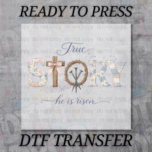 May include: A DTF transfer design with the words "READY TO PRESS" and "DTF TRANSFER" at the top and bottom. The design features the words "True Story" with a cross, crown of thorns, and nails. The words "he is risen" are also included.