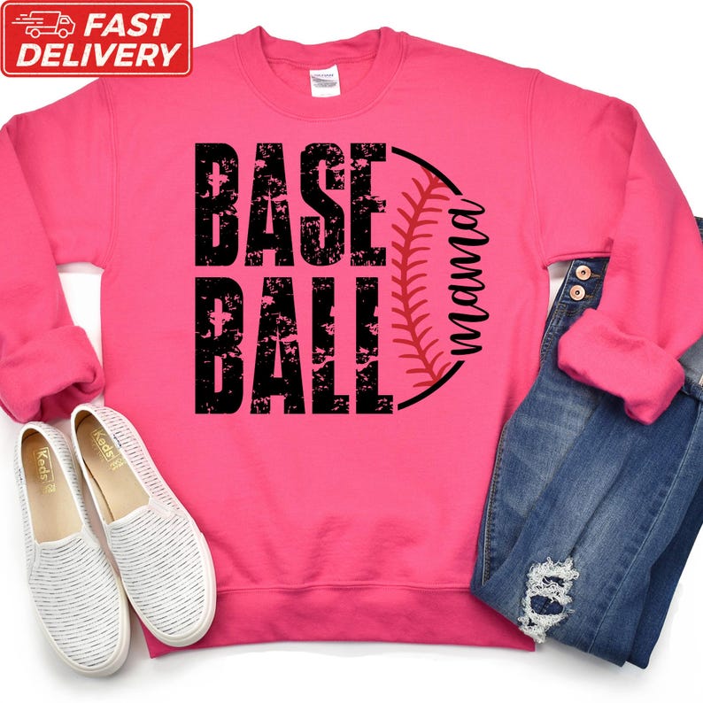 A pink sweatshirt with the text "BASE BALL" printed on it, along with a baseball graphic, is displayed alongside a pair of white sneakers and a pair of blue jeans.
