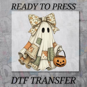 May include: A DTF transfer featuring a ghost illustration with a large floral bow on its head and a patchwork-style sheet. The ghost holds an orange jack-o'-lantern bucket. The text READY TO PRESS DTF TRANSFER is visible on the image.