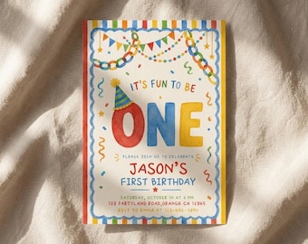 May include: A rectangular birthday invitation card featuring a watercolor design with a blue scalloped border and colorful stripes. The text reads IT'S FUN TO BE ONE, JASON'S FIRST BIRTHDAY, and includes event details like the date, time, and location.
