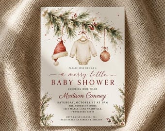 May include: A rectangular invitation card featuring a watercolor illustration of pine branches with red berries, a red Santa hat, a cream-colored baby onesie, and a red ornament. The text reads: Please join us for a merry little baby shower.