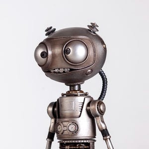 May include: A detailed, metallic robot figurine with a round head, large eyes, and articulated limbs. The robot stands on a black circular base. The color palette includes silver, gray, and black, creating a vintage, industrial aesthetic. The robot's design suggests a retro-futuristic theme.