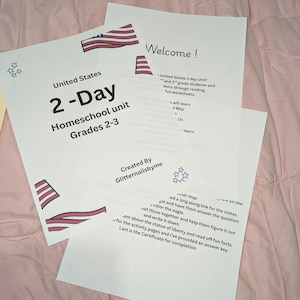 May include: A printed educational homeschool unit for grades 2-3 titled United States 2-Day Homeschool unit. The white paper features red, white, and blue flag graphics, star outlines, and text detailing lesson plans, map activities, and a completion certificate.