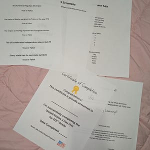 May include: A set of printed educational worksheets for a United States history unit, including a True or False quiz, a word scramble, an answer key, and a Certificate of Completion for 2nd and 3rd grade students, featuring black text on white paper.