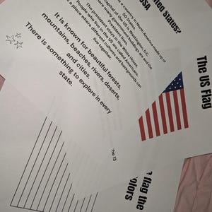 May include: Educational worksheets about the United States featuring black text on white paper. One sheet includes a US flag graphic, text about the country, and three small star icons. Another sheet shows vertical lines and the text the flag the colors.