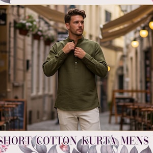 May include: An olive green short cotton kurta shirt with a mandarin collar and long sleeves. The shirt is buttoned at the neck and paired with cream-coloured trousers. The text "SHORT COTTON KURTA MENS" is at the bottom of the image.