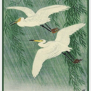 May include: Japanese-style print featuring two white birds in flight against a backdrop of green foliage and rain. The birds have long black legs, yellow beaks, and are set against a green and white background.