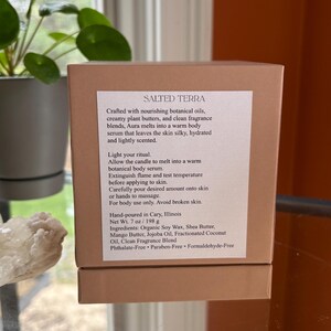 May include: A brown box with the text "SALTED TERRA" and product information. The box contains a body serum with botanical oils and fragrance blends. The net weight is 7 oz (198 g).