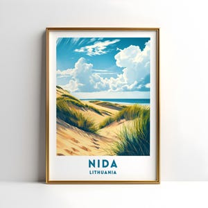 May include: Framed art print featuring a coastal landscape with sand dunes, green grasses, and a blue ocean under a bright sky with fluffy white clouds. The print includes the text "NIDA LITHUANIA" in a white rectangular box.