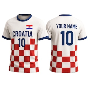 May include: White Croatia football shirt with a red and white chequered pattern on the lower front. The shirt features the Croatian flag, the word "CROATIA", and the number "10" on the front. The back has "YOUR NAME" and the number "10".