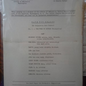 May include: A black and white document with the title "HAVE YOU HEARD?" and the text "No. 1 - THE WORK OF RIVERS (Graduation)". The document lists the cast of characters for a radio play, including the Friendly Guide, The Girl, Nancy, Lee, Pa, Jud, Court Crier, Chief Justice, Dyar, Gregory, and Keeling.