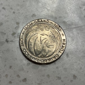MGM 1993 One dollar (1) gaming token MGM Grand DINA Las Vegas Nevada 1 1/2 inch diameter