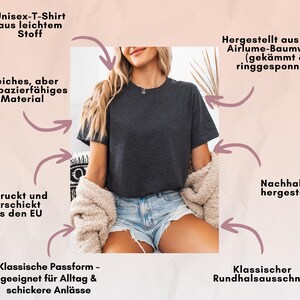 May include: A dark gray unisex t-shirt with a classic crew neck. The shirt is made of soft, durable material and is sustainably produced. The image includes text in German describing the shirt's features, including its lightweight fabric and classic fit.