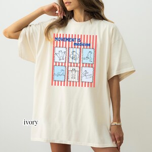 frogs doing therapy exercises on a Comfort Colors® t-shirt with “movement is medicine” text with stamps and lines in background design, printed on soft cotton shirt in various earthy tones
