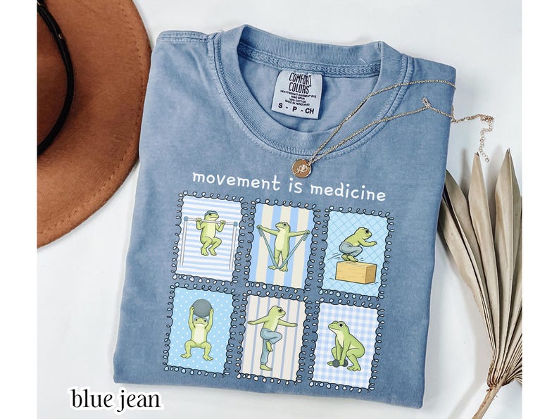 green frogs doing therapy exercises on a Comfort Colors® t-shirt with “movement is medicine” text with stamps design, printed on soft cotton shirt in various earthy tones