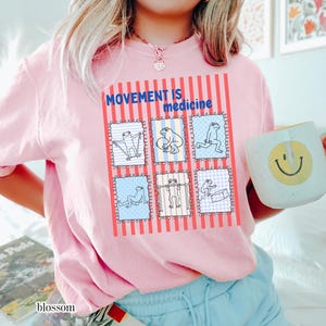 frogs doing therapy exercises on a Comfort Colors® t-shirt with “movement is medicine” text with stamps and lines in background design, printed on soft cotton shirt in various earthy tones