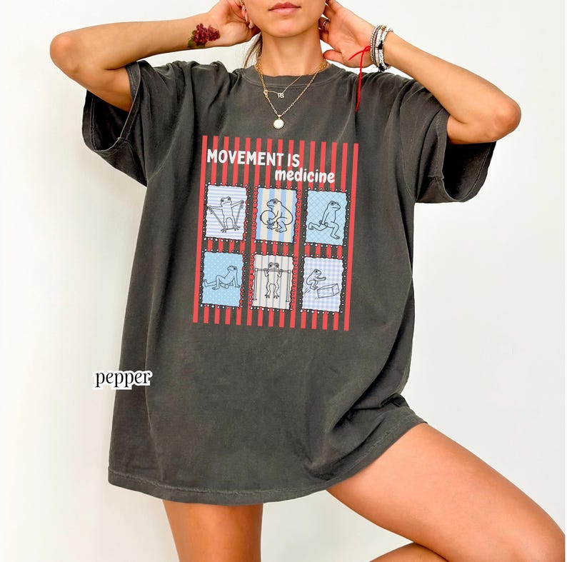 frogs doing therapy exercises on a Comfort Colors® t-shirt with “movement is medicine” text with stamps and lines in background design, printed on soft cotton shirt in various earthy tones