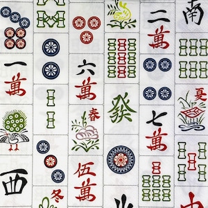 May include: A close-up of a white surface covered in Mahjong tiles. The tiles feature various symbols, characters, and colourful designs in red, green, blue, and black. The image showcases a variety of tile types, including characters and suit symbols.