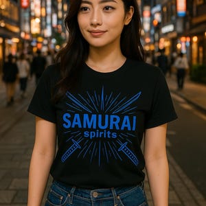 May include: Black t-shirt with the words "SAMURAI spirits" in blue, along with a graphic of two swords and a sunburst design. The person is wearing blue jeans. The background is a city street at night.