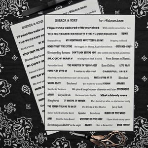 May include: Two white cards with the text "HORROR & GORE" and various phrases like "BLOODY MARY" and "THE SCREAMS BENEATH THE FLOORBOARDS". The cards are on a black and white paisley bandana, with tweezers and scissors.