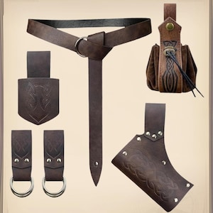 May include: A set of brown leather accessories, including a belt with a metal ring, a pouch with a drawstring, and various holders with silver rivets. The items feature Celtic knotwork designs.