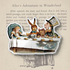 May include: A die-cut sticker featuring a scene from "Alice's Adventures in Wonderland." The image depicts Alice, the Mad Hatter, the March Hare, and a small animal at a tea party. The sticker is on a background of book pages.
