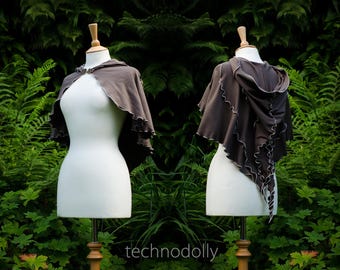 May include: A brown hooded cape with a ruffled edge and a drawstring closure. The cape is made of a soft, comfortable fabric and is perfect for layering over any outfit.