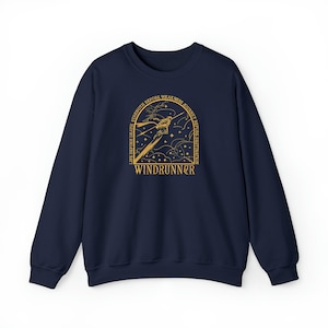 May include: A navy blue sweatshirt with a gold graphic. The design includes a stylized figure, the word "WINDRUNNER", and the text "LIFE BEFORE DEATH, STRENGTH BEFORE WEAKNESS, JOURNEY BEFORE DESTINATION".