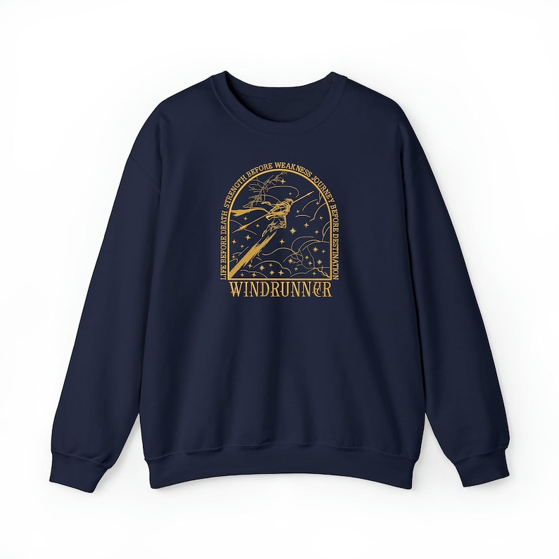 May include: A navy blue sweatshirt with a gold graphic design. The design features a stylized figure with the word "WINDRUNNER" and the text "LIFE BEFORE DEATH, STRENGTH BEFORE WEAKNESS, JOURNEY BEFORE DESTINATION".