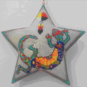 May include: A star-shaped beaded pillow with a colorful beaded lizard design. The lizard is curled up in a circle with its tail wrapped around its body. The star is white with a turquoise border.