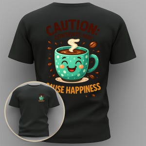 May include: Black t-shirt with a teal coffee cup graphic. The cup has a smiling face and is surrounded by coffee beans. Text on the shirt reads "CAUTION: CONTENTS MAY CAUSE HAPPINESS."