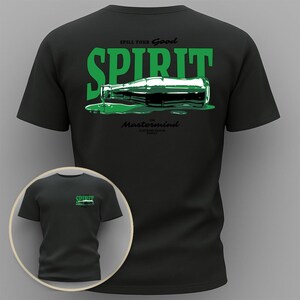 May include: A white ceramic mug with a black handle and the text "But First, Coffee" in a black, handwritten-style font. The mug is on a white surface.