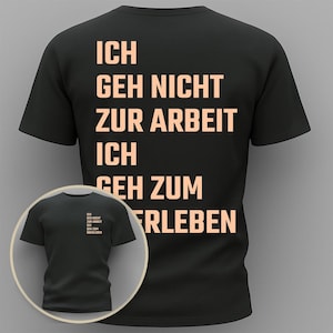 Puede incluir: Camiseta negra con texto color melocotón. El texto en la parte posterior dice "ICH GEH NICHT ZUR ARBEIT ICH GEH ZUM ERLEBEN". Una imagen más pequeña de la camiseta está en la esquina inferior izquierda.