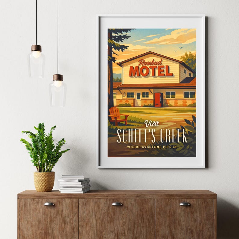 May include: Framed art print featuring a vintage-style illustration of the Rosebud Motel from Schitt's Creek. The artwork showcases the motel's exterior with the text "Visit Schitt's Creek" and "Where Everyone Fits In."