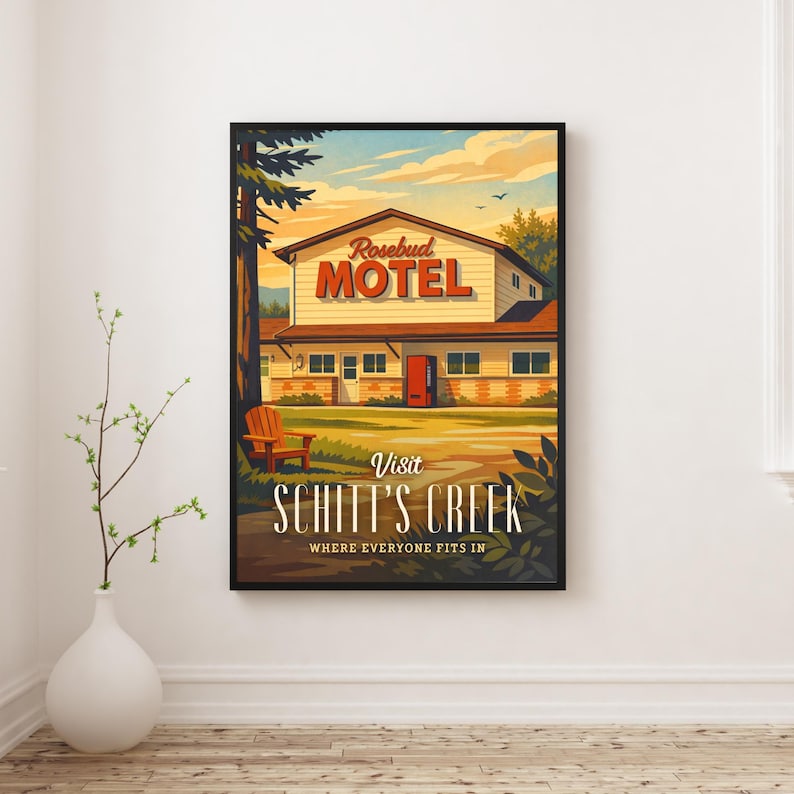 May include: Framed art print featuring a vintage-style illustration of the Rosebud Motel from Schitt's Creek. The artwork showcases the motel's exterior, a wooden chair, and the text "Visit Schitt's Creek, Where Everyone Fits In."