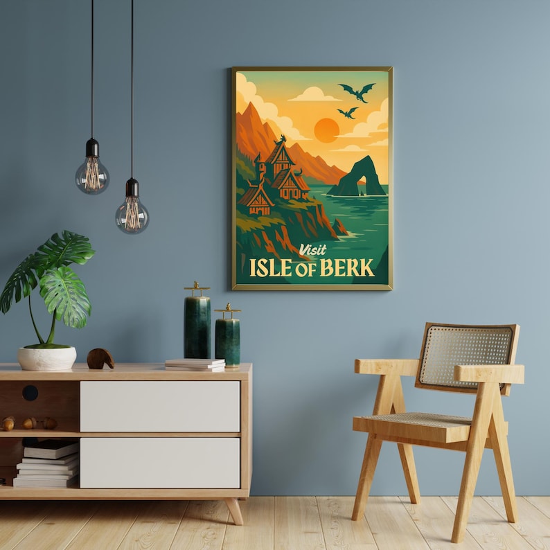 May include: A framed poster with a vintage travel theme. The artwork depicts a coastal landscape with mountains, buildings, and the text "Visit Isle of Berk." The color palette includes orange, green, and blue tones, with two flying creatures in the sky.