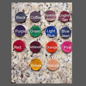 Peut inclure: Une collection de petits &eacute;chantillons de cuir ronds de diff&eacute;rentes couleurs, dont noir, caf&eacute;, marron, beige, violet, vert, bleu clair, bleu jean, rouge, bordeaux, orange, rose, jaune et naturel. Chaque &eacute;chantillon est &eacute;tiquet&eacute; avec son nom de couleur.