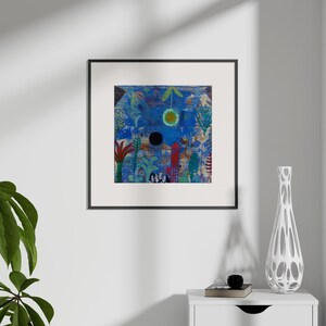 May include: Abstract art print in a black frame. The artwork features a blue background with colourful shapes, a black circle, and a yellow sun. A white vase with a unique design sits on a white table.