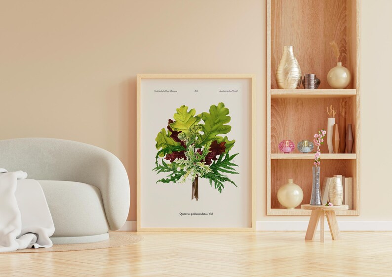May include: Botanical print of a plant with green and maroon leaves, framed in light wood. The print is leaning against a wall, next to a light-coloured sofa and a wooden shelf with decorative vases.