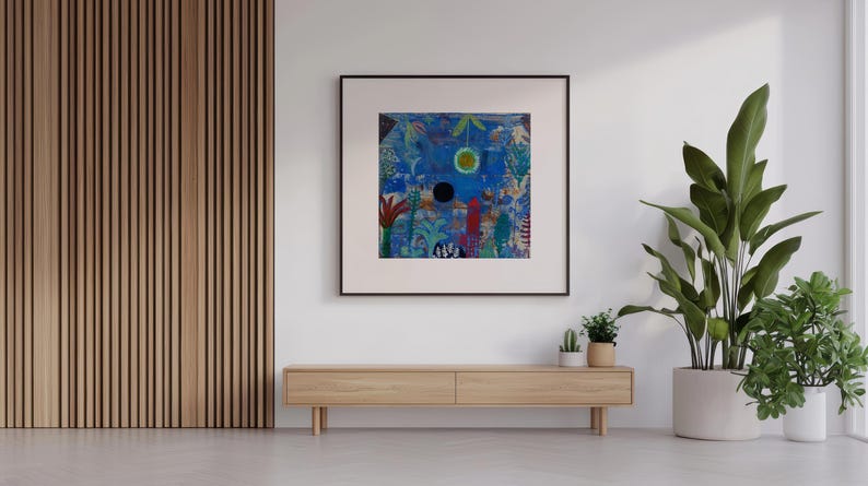May include: An abstract artwork in a black frame, featuring blue and green hues, hangs on a white wall. Below, a wooden cabinet is positioned. A large potted plant is to the right. The room has a modern, minimalist design.