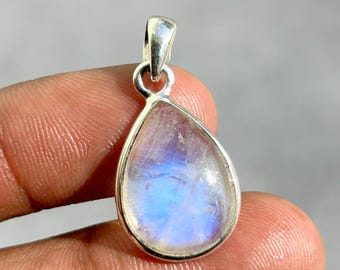 May include: A teardrop-shaped pendant with a silver-colored bail. The pendant features a translucent, iridescent stone with blue and white hues. The stone is set in a silver-colored metal frame, creating a simple yet elegant design.