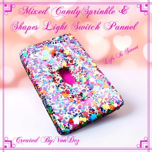 Könnte beinhalten: Ein Lichtschalter-Abdeckung mit einem bunten Streusel-Design. Die Abdeckung ist aus Harz und hat eine klare Oberfläche. Der Text "Life Is Sweet" ist im Hintergrund sichtbar.