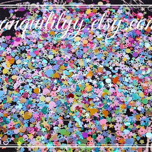 May include: A mix of colorful glitter featuring stars, hearts, moons, and other shapes. The glitter is perfect for adding sparkle to crafts, nail art, and resin projects.