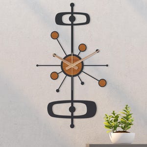 May include: A mid-century modern wall clock with a black frame and wooden accents. The clock features a circular face with wooden hands and a starburst design. The clock's dimensions are approximately 30 inches in height.