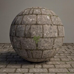 May include: A spherical structure made of grey stone blocks, similar to a large ball. The surface shows signs of weathering and age, with patches of moss and a small green plant growing from a crevice. It rests on a cobblestone surface.