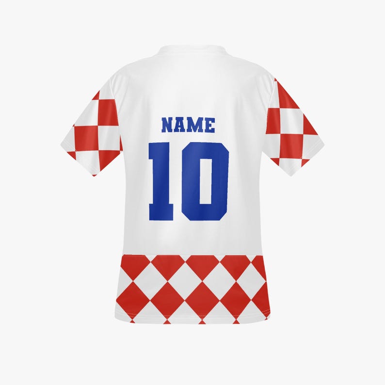 May include: White soccer jersey with red and white checkered accents on the sleeves and hem. The jersey features the number 10 in blue, with the word "NAME" above it. The jersey is a sports-themed item.